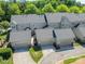 Aerial view of townhomes featuring attached garages and well-maintained landscaping at 815 Jetton St, Davidson, NC 28036