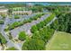 Aerial view showcasing the neighborhood, mature trees, nearby lake and office buildings at 815 Jetton St, Davidson, NC 28036