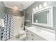 Neutral bathroom with tub, shower and white vanity at 815 Jetton St, Davidson, NC 28036