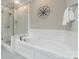 Bright bathroom featuring a soaking tub, glass shower and neutral tile work at 815 Jetton St, Davidson, NC 28036