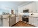 An open concept kitchen with white cabinets and stainless steel appliances at 815 Jetton St, Davidson, NC 28036