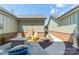 Charming outdoor space with ample seating and lush landscaping and brick accent wall at 815 Jetton St, Davidson, NC 28036