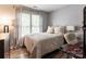 Well-lit bedroom featuring neutral walls, plush bedding, and a cozy workspace at 8532 Piccone Brook Ln, Charlotte, NC 28216