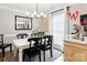 Cozy dining room with a white table, seating for six, and a modern chandelier at 8532 Piccone Brook Ln, Charlotte, NC 28216