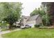 Inviting two-story home with a well-manicured lawn, mature trees, and attached two-car garage at 8532 Piccone Brook Ln, Charlotte, NC 28216