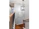 Upstairs hallway with decorative lighting fixture, staircase and artwork at 8532 Piccone Brook Ln, Charlotte, NC 28216