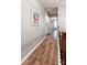 Upstairs hallway with hardwood floors leading to laundry room and bedrooms at 8532 Piccone Brook Ln, Charlotte, NC 28216