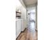 Convenient laundry room with washer, dryer, shelving, and a view into the bedroom at 8532 Piccone Brook Ln, Charlotte, NC 28216