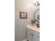Stylish powder room featuring a modern vanity, updated light fixture and decor at 8532 Piccone Brook Ln, Charlotte, NC 28216