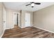 Neutral bedroom offers durable wood-look flooring, a ceiling fan, and two entries at 8610 Sawleaf Ct, Charlotte, NC 28215