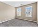 This cozy bedroom has neutral walls, large windows, and plush carpet at 8610 Sawleaf Ct, Charlotte, NC 28215
