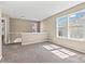 Bright bonus room featuring large windows and neutral carpet, perfect for flexible living space at 8610 Sawleaf Ct, Charlotte, NC 28215