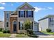 Charming two-story home featuring black shutters, brick accents, and a well-maintained front yard at 8610 Sawleaf Ct, Charlotte, NC 28215
