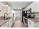 Updated kitchen with granite counters, stainless appliances, white cabinets, and durable wood-look floors at 8610 Sawleaf Ct, Charlotte, NC 28215