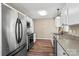 Well-equipped kitchen with granite countertops, stainless steel appliances, and wood-look flooring at 8610 Sawleaf Ct, Charlotte, NC 28215