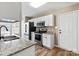 Modern kitchen boasts stainless appliances, granite counters, ample cabinetry and light wood-look floors at 8610 Sawleaf Ct, Charlotte, NC 28215