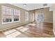Bright living room featuring large windows and patio doors allowing ample sunlight at 8610 Sawleaf Ct, Charlotte, NC 28215