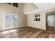 An open-concept living room with hardwood floors and adjacent breakfast bar at 8610 Sawleaf Ct, Charlotte, NC 28215