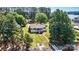 Aerial view of home showcasing large front yard, mature trees, dock and lake access at 9561 Island Point Rd, Sherrills Ford, NC 28673