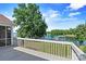 Relaxing back deck with a view of the lake, mature trees, and a covered boat dock at 9561 Island Point Rd, Sherrills Ford, NC 28673