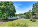 Lush backyard with a walkway leading to a covered dock, perfect for enjoying waterfront living at 9561 Island Point Rd, Sherrills Ford, NC 28673