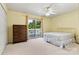 Bedroom with light-yellow walls, large window and door leading to the deck at 9561 Island Point Rd, Sherrills Ford, NC 28673