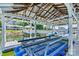 Covered boat dock featuring boat lift and picturesque views of the lake and surrounding waterfront homes at 9561 Island Point Rd, Sherrills Ford, NC 28673