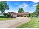 Charming one-story brick home featuring attached garage, well-manicured lawn, and welcoming driveway at 9561 Island Point Rd, Sherrills Ford, NC 28673