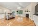 Cozy living area featuring hardwood floors, a fireplace, and large windows offering abundant natural light at 9561 Island Point Rd, Sherrills Ford, NC 28673