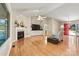 Cozy living room featuring fireplace, hardwood floors, and ample natural light at 9561 Island Point Rd, Sherrills Ford, NC 28673