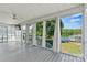 Spacious screened-in porch with ceiling fan, offering tranquil views of the lake and outdoor scenery at 9561 Island Point Rd, Sherrills Ford, NC 28673