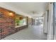 Large porch with brick exterior, ceiling fan, and curtains, perfect for outdoor relaxation and entertaining at 9561 Island Point Rd, Sherrills Ford, NC 28673