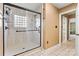 Bright bathroom features a glass shower with a tiled surround and a convenient grab bar at 9561 Island Point Rd, Sherrills Ford, NC 28673