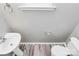 Cozy half bathroom featuring pedestal sink, modern fixtures, and neutral wall color at 10606 Gallowgate Ln, Charlotte, NC 28213