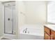 Bright bathroom with a glass door shower and a separate soaking tub at 10606 Gallowgate Ln, Charlotte, NC 28213