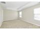 Spacious bedroom with neutral carpet and natural light from two windows at 10606 Gallowgate Ln, Charlotte, NC 28213