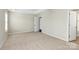 Carpeted bedroom featuring a tray ceiling, natural light, and an open doorway at 10606 Gallowgate Ln, Charlotte, NC 28213
