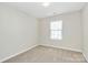 Simple, carpeted bedroom with neutral walls and a bright window at 10606 Gallowgate Ln, Charlotte, NC 28213