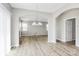 Open dining room, leading to the living room, offers new flooring and a modern chandelier at 10606 Gallowgate Ln, Charlotte, NC 28213