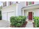 View of the exterior, featuring a red door and a two-car garage at 10606 Gallowgate Ln, Charlotte, NC 28213