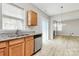 Kitchen with stainless steel dishwasher and granite counters flowing into dining area at 10606 Gallowgate Ln, Charlotte, NC 28213