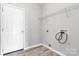 Laundry room with white door, wire rack, and hook ups for washer and dryer at 10606 Gallowgate Ln, Charlotte, NC 28213