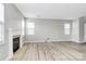 Bright, open living room with a cozy fireplace and hardwood floors throughout at 10606 Gallowgate Ln, Charlotte, NC 28213