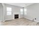 Well-lit living room features a charming fireplace and hardwood flooring at 10606 Gallowgate Ln, Charlotte, NC 28213