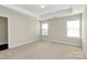 Spacious main bedroom featuring tray ceilings and two bright windows at 10606 Gallowgate Ln, Charlotte, NC 28213