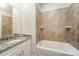 Bathroom featuring granite counters, a tub, and a shower at 107 S Sina St, Troutman, NC 28166