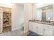 Bright bathroom with walk-in closet, granite counters, and tile shower at 107 S Sina St, Troutman, NC 28166