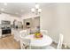 Open dining and kitchen space featuring stainless appliances, granite counters, and a view into the living room at 107 S Sina St, Troutman, NC 28166