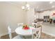 Bright eat-in kitchen features a white table and chairs, and is open to a modern kitchen at 107 S Sina St, Troutman, NC 28166