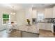 Well-lit eat-in kitchen with an island and stainless steel appliances, perfect for Gathering meals and entertaining at 107 S Sina St, Troutman, NC 28166